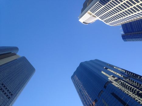 Look up to blue sky to see high rise financial buildings