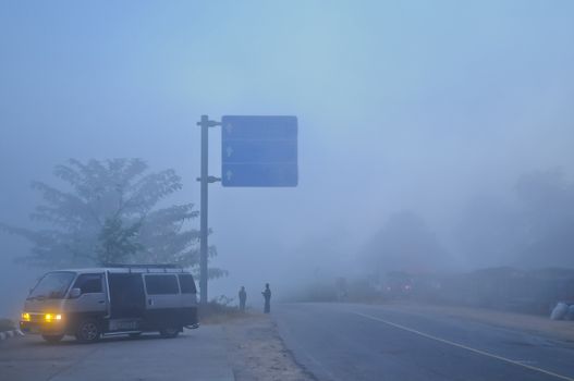 Foggy Misty early morning road to the peak of mountain in Northern Thailand in Winter