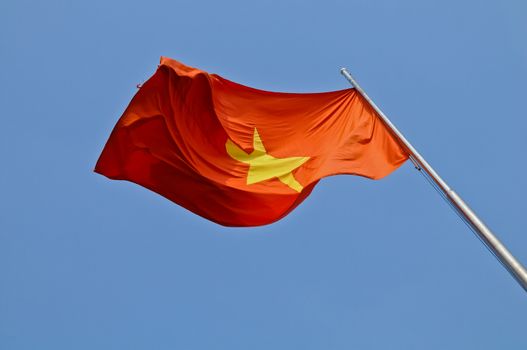 Vietnam national flag flying in blue sky