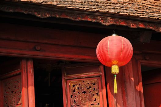 Classical red paper Chinese lantern in sacred shrine in Hanoi Vietnam