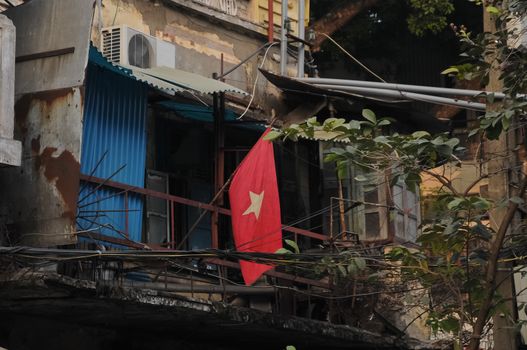 Vietnam national flag and old poor townhouse