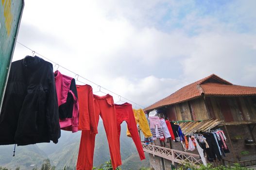 Various colour of clothes hanging in villager's cottage