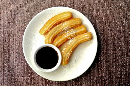 Freshly made Spanish crispy churros with dark chocolate dipping sauce