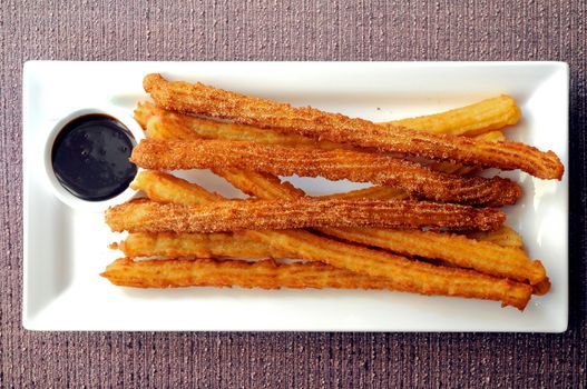 Spanish donut Churros freshly made with dark chocolate dipping sauce