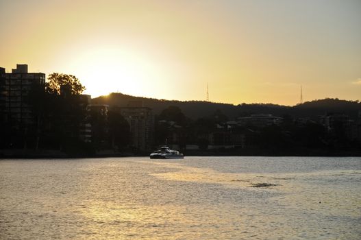 A ferry in Brisbane River at the sun set time