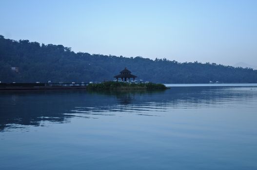 Chinese pavilion nearby the peaceful lake in early morning