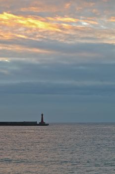 A lighthouse and the calm sea in early morning