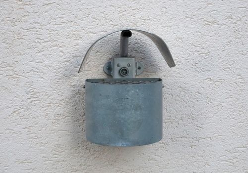 Exterior wall mounted ashtray made from metal