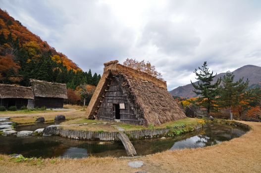 Autumn magical scene of Triangular ancient local cottage and a small pond in Shirakawago village in Takayama Japan