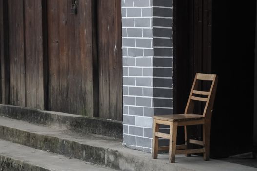 Old chair in front of Chinese vintage house