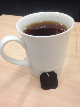 Hot black tea in white cup