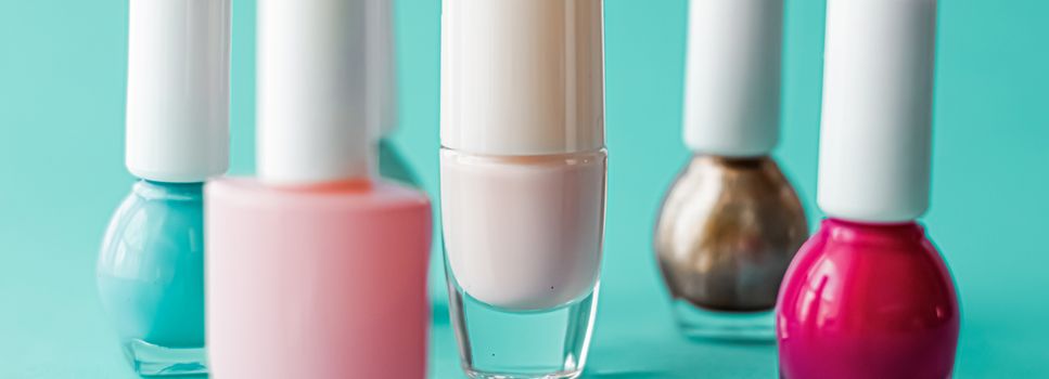 Nail polish bottles on green background, beauty branding