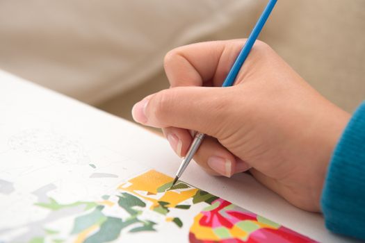 7 - Bright white painting by numbers, copy space to the left hand side. A covid quarantine lock down hobby and pass time. Detail on the brush tip