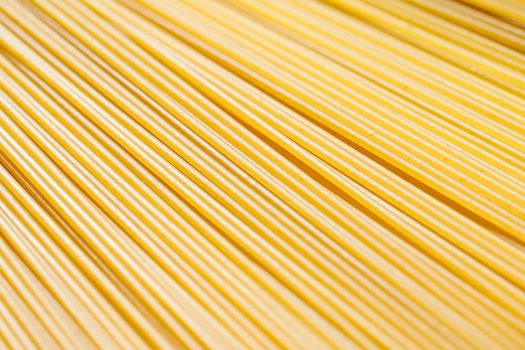 Uncooked whole grain spaghetti closeup, italian pasta as organic food ingredient, macro product and cook book recipes