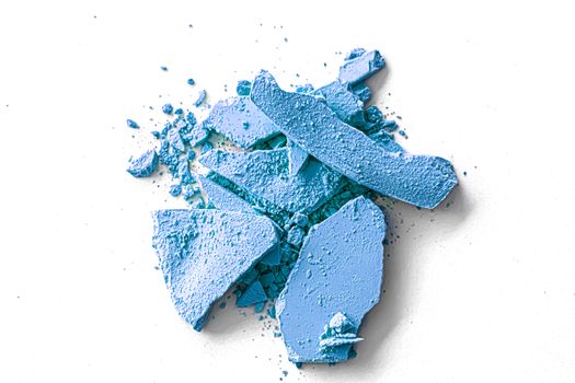 Blue eye shadow powder as makeup palette closeup isolated on white background, crushed cosmetics and beauty textures