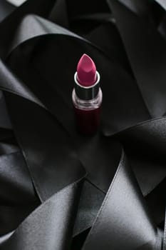 Pink lipstick on black silk background, luxury make-up and beauty cosmetics