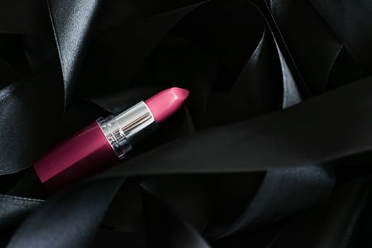 Pink lipstick on black silk background, luxury make-up and beauty cosmetics