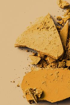 Yellow eye shadow powder as makeup palette closeup, crushed cosmetics and beauty textures