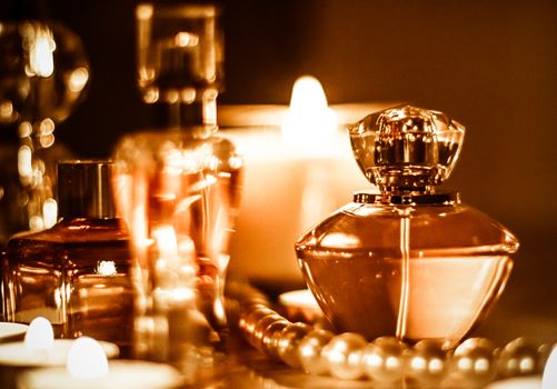 Perfumery, cosmetics branding and luxe concept - Perfume bottle and vintage fragrance on glamour vanity table at night, pearls jewellery and eau de parfum as holiday gift, luxury beauty brand present