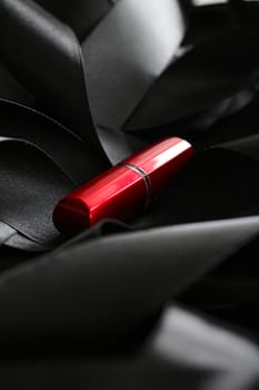 Red lipstick on black silk background, luxury make-up and beauty cosmetics