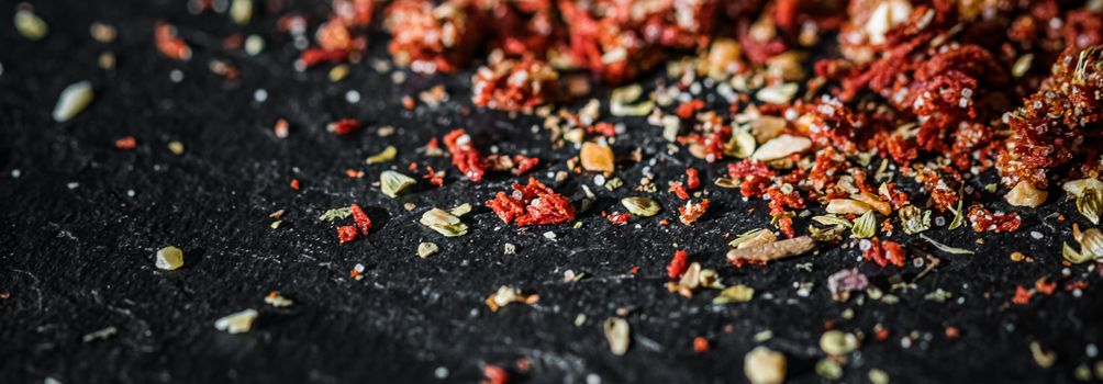 Dried tomato and chili pepper closeup on luxury stone background as flat lay, dry food spices and recipe ingredients