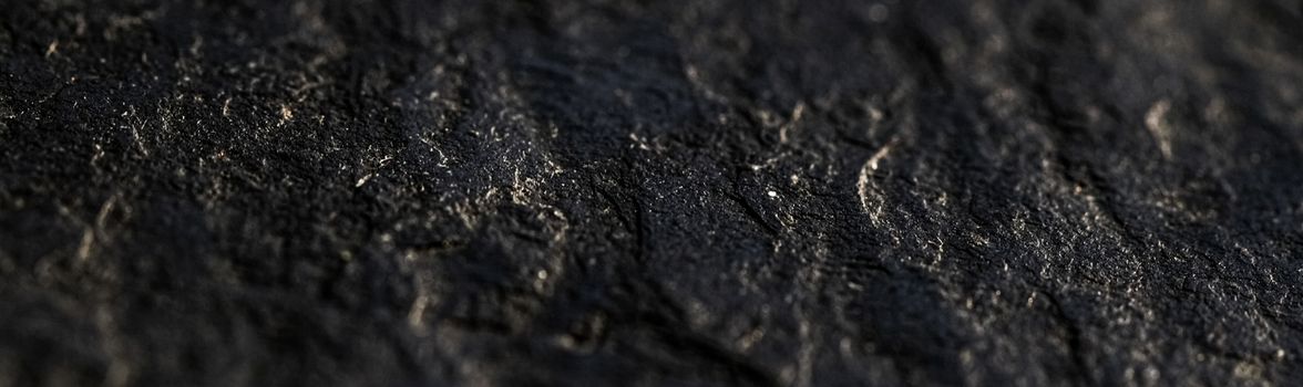 Black stone texture as abstract background, design material and textured surfaces