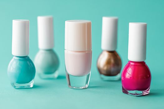 Nail polish bottles on green background, beauty branding