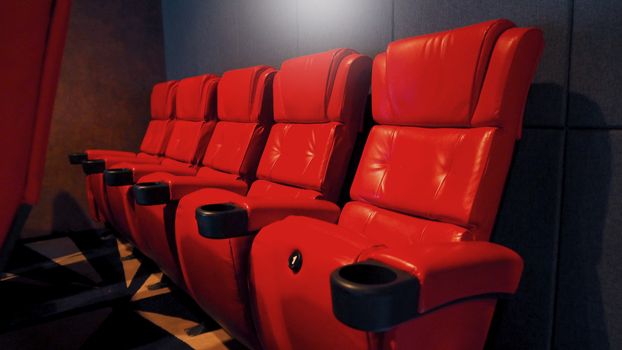 Red color leather movie theater cinema seat chairs which small and old dirty and very bad stingy smell.