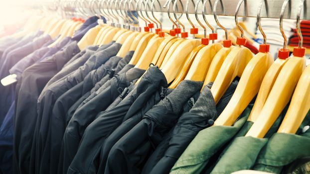 Clothes or shirt and hanger on shelf in store for sale and close-up angle view. 