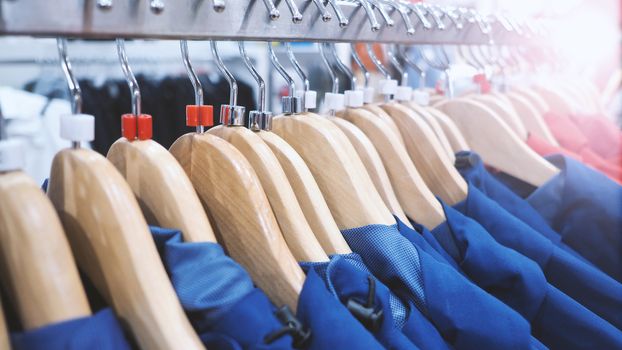 Clothes or shirt and hanger on shelf in store for sale and close-up angle view. 