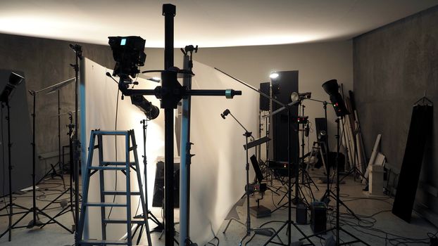 Studio lighting setup for photo shooting production with many equipment such as softbox, backdrop paper, white reflect foam and many more.