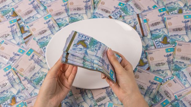 A lot of Kazakhstan tenge in a circle on the table. The national currency of Kazakhstan. Salary in tenge. Grocery basket, budget savings. Divide the budget. Kazakhstan banks and loans in tenge