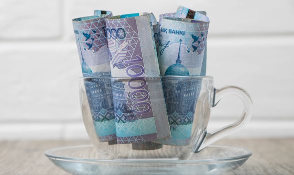 A lot of money Kazakhstan tenge in a cup on the table. The national currency of Kazakhstan. Salary in tenge. Grocery basket, budget savings. Divide the budget. Kazakhstan banks and loans in tenge