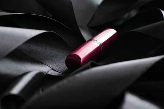 Pink lipstick on black silk background, luxury make-up and beauty cosmetics