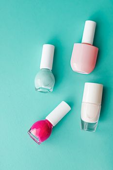 Nail polish bottles on green background, beauty branding