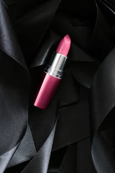 Pink lipstick on black silk background, luxury make-up and beauty cosmetics