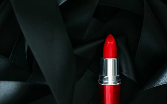 Red lipstick on black silk background, luxury make-up and beauty cosmetics