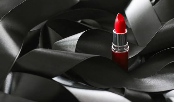 Red lipstick on black silk background, luxury make-up and beauty cosmetics