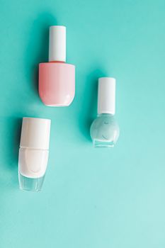 Nail polish bottles on green background, beauty branding