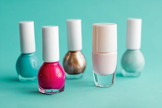 Nail polish bottles on green background, beauty branding