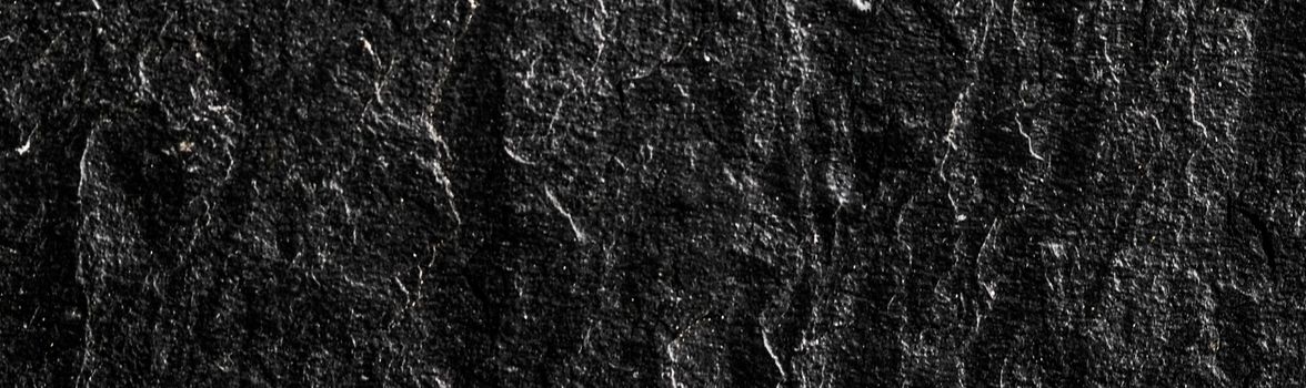 Black stone texture as abstract background, design material and textured surfaces