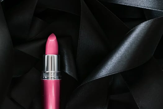 Pink lipstick on black silk background, luxury make-up and beauty cosmetics