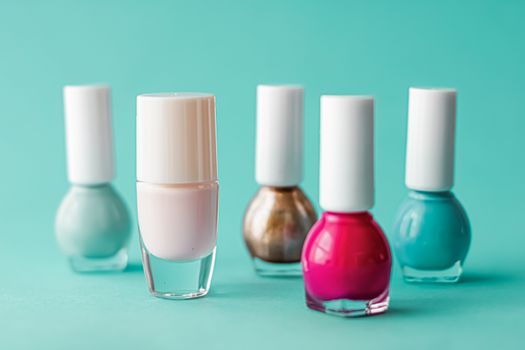 Nail polish bottles on green background, beauty branding