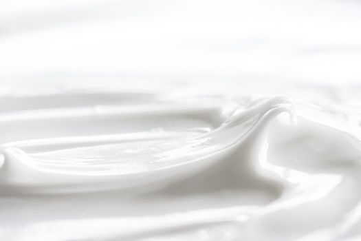 Pure white cream texture as abstract background, food substance or organic cosmetics