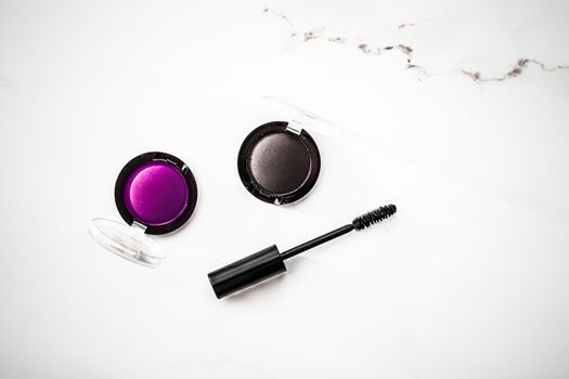 Cosmetic branding, blog and girly concept - Eyeshadows, black liner and mascara on marble background, eye shadows cosmetics as glamour make-up products for luxury beauty brand, holiday flatlay design