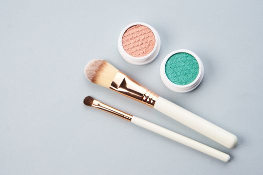 makeup brushes eyeshadow collection professional cosmetics on gray background. High quality photo