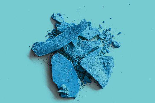 Blue eye shadow powder as makeup palette closeup, crushed cosmetics and beauty textures