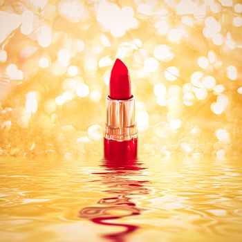 Red lipstick on golden background, make-up and cosmetics product