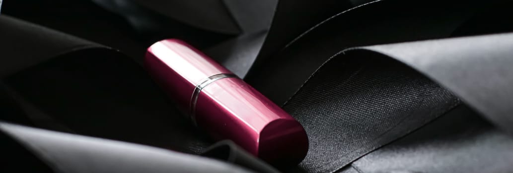 Pink lipstick on black silk background, luxury make-up and beauty cosmetics