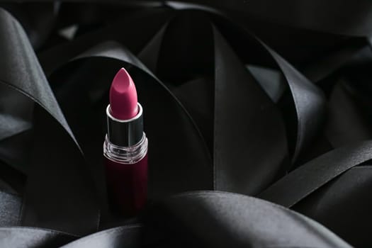 Pink lipstick on black silk background, luxury make-up and beauty cosmetics